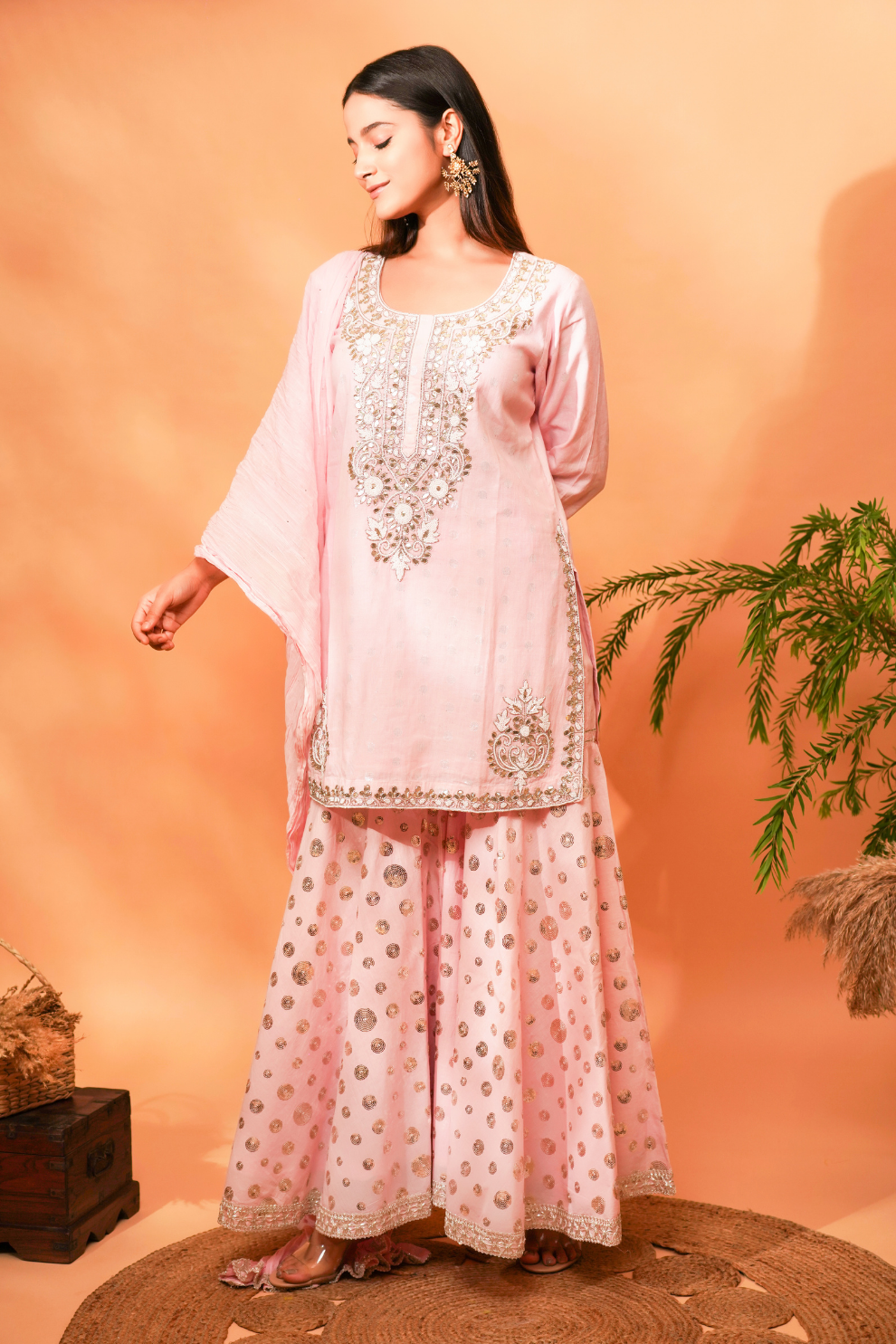 Pink lurex kurta with bead work on the neckline paired with sequin garara