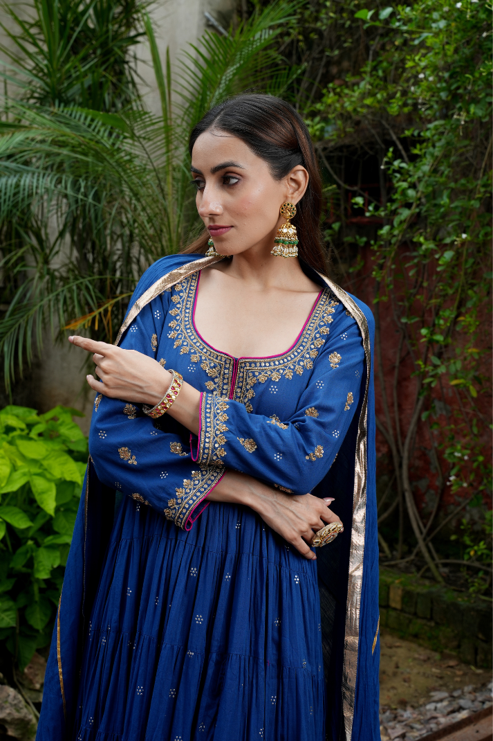 A blue anarkali  with delicate gold motifs