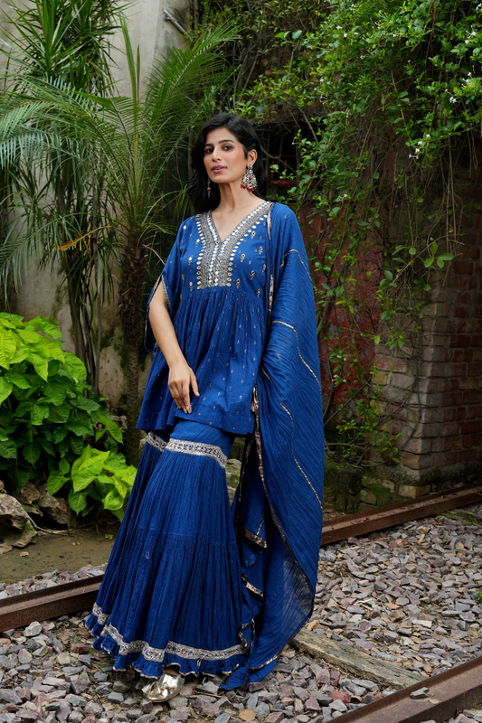 A deep blue short kurta Paired with flared sharara