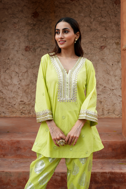 A fresh lime-green kurta with zari-woven floral motifs pants