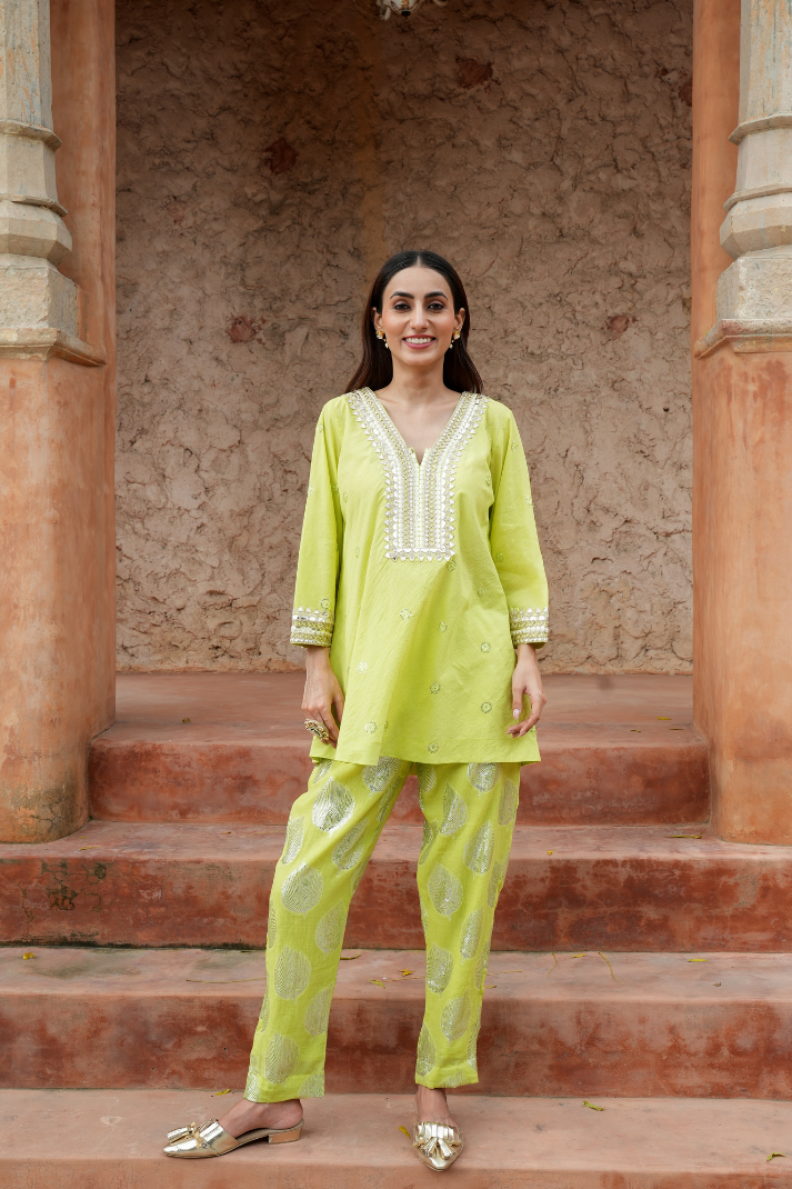 A fresh lime-green kurta with zari-woven floral motifs pants