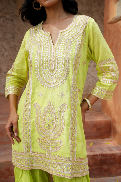 A vibrant lime-green kurta Paired with a flowy salwar