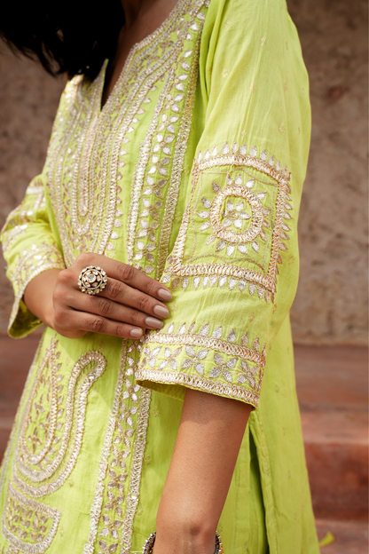 A vibrant lime-green kurta Paired with a flowy salwar